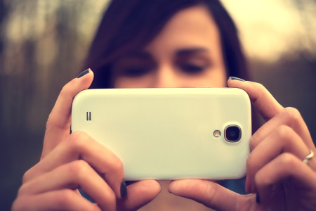 Portrait of beautiful young woman take a photo with mobile phone